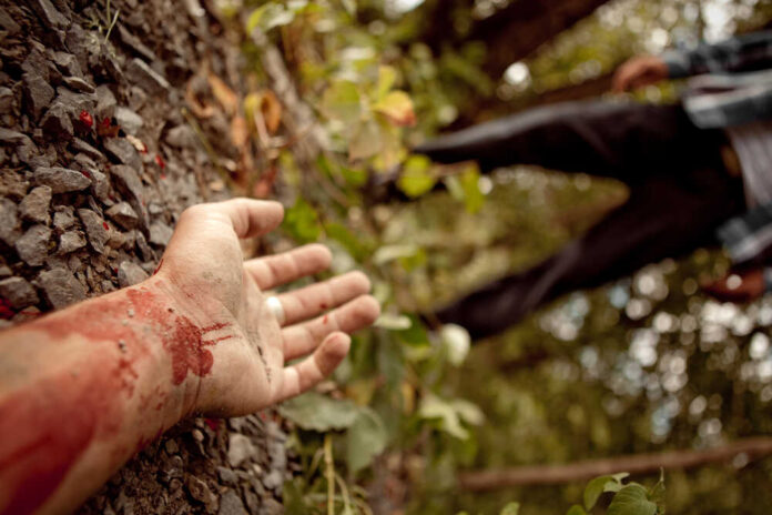 Murdered,Man's,Hand,Lying,On,The,Ground,In,The,Middle