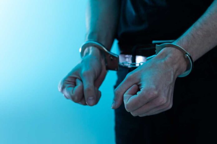 Young,Man,Desperate,To,Catch,The,Iron,Prison,prisoner,Concept,handcuffed,Hands