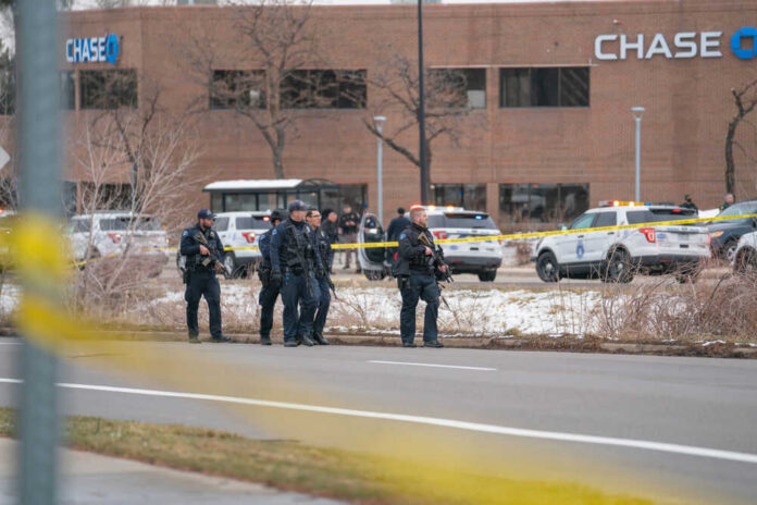 Police officers outside Chase bank near yellow tape