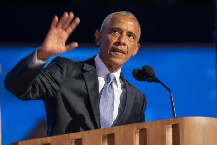 A man in a suit delivering a speech at a podium