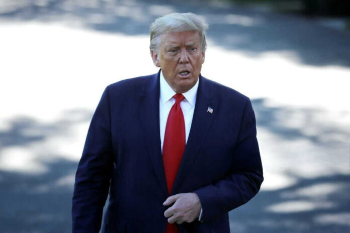 Man in suit with red tie walking outside