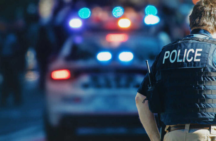 shooting-at-feather-river-school-of-seventh-day-adventists-in-palermo-california-two-students-wounded-suspect-deceased Police officer standing with patrol car in background