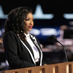 Woman speaking at a podium in formal attire