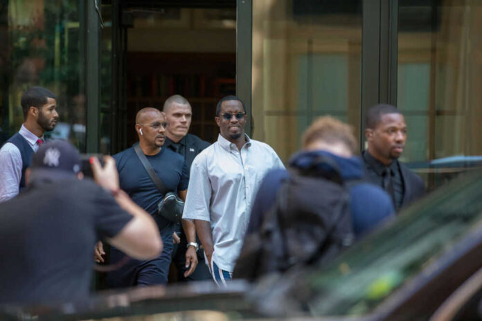 Group of men walking outdoors surrounded by photographers