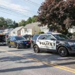 Police and ambulance vehicles parked on street
