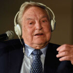 Man wearing headphones speaking into a microphone