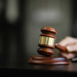 Wooden gavel on a dark surface