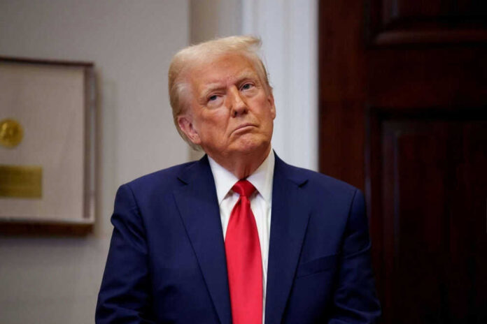 Man in suit with red tie looking contemplative