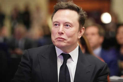 Man in suit at an event looking sideways
