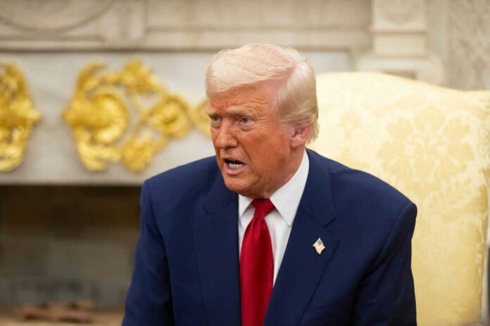Man in a suit speaking in an ornate room