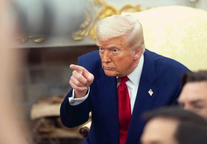Man in blue suit pointing forward with intent