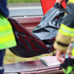 Emergency responders with black bag near roadside