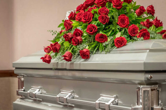 Casket with red roses on top