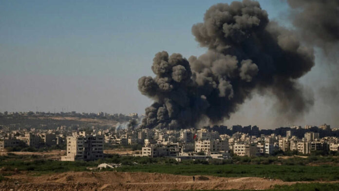 Smoke rising over city buildings from explosion