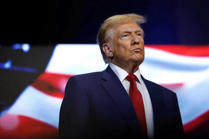 Person in suit with American flag in background