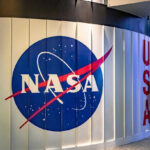 NASA Insider UNLEASHES Disturbing ISS Truth NASA logo on a curved wall display