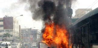Car engulfed in flames on busy urban street