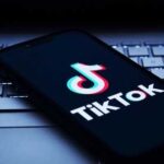 Smartphone displaying the TikTok logo on a keyboard