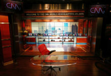 News studio with chair desk and city backdrop