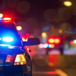 Police car with flashing lights at night