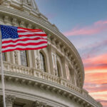 Power Vacuum at TPUSA Sparks Big Claims American flag and Capitol building against colorful sky