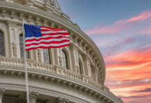 Power Vacuum at TPUSA Sparks Big Claims American flag and Capitol building against colorful sky